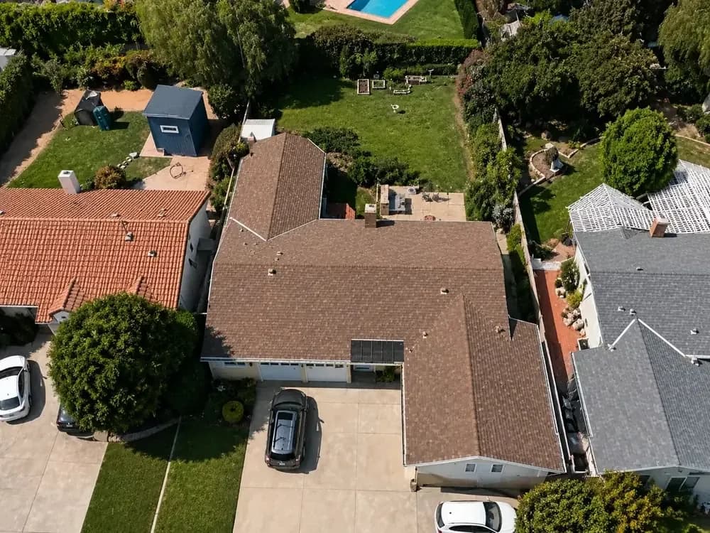 Aerial view of a residential property before an ADU concept is placed on it